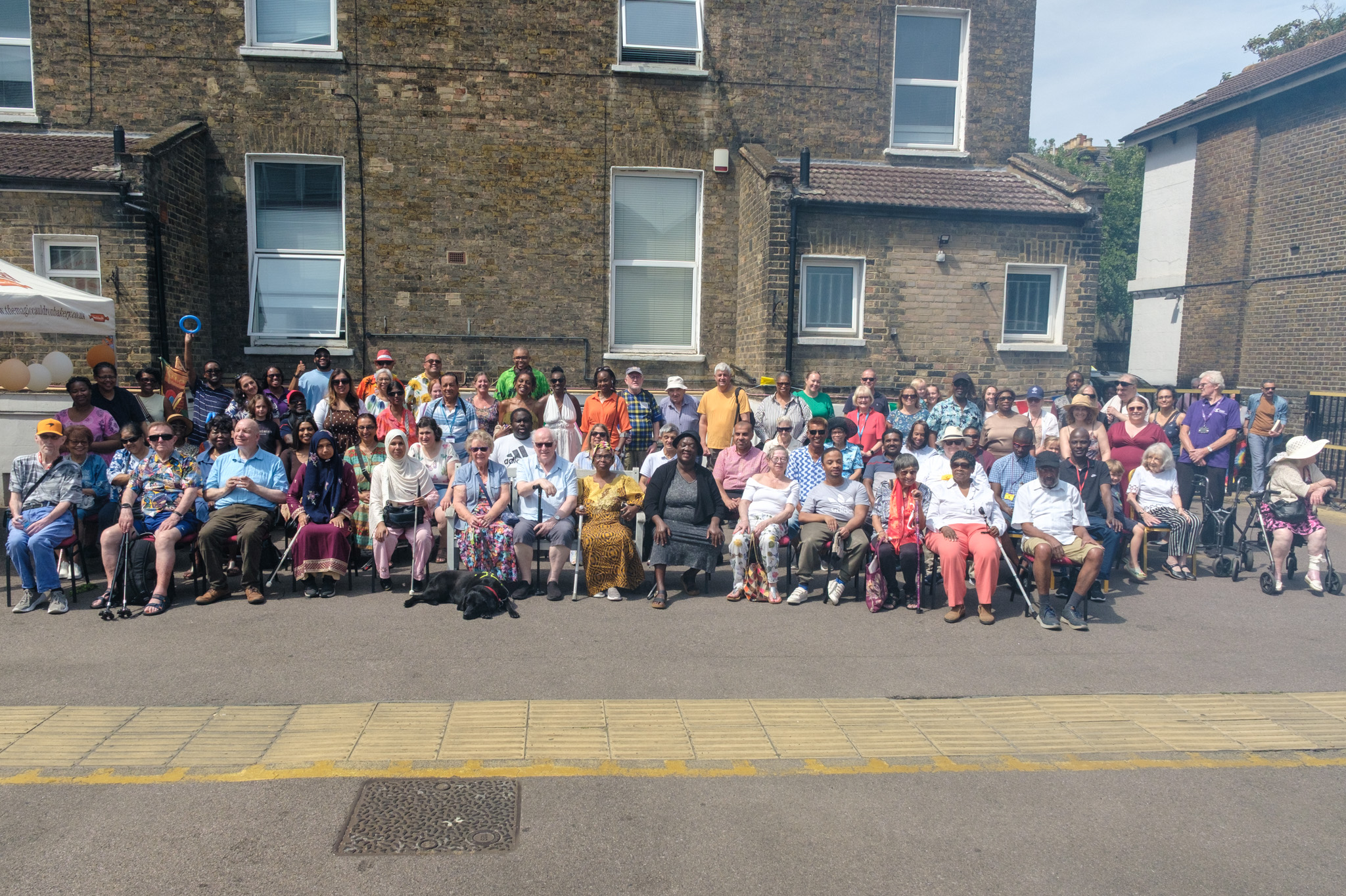Croydon Vision members, staff, volunteers and guests gathered outdoors for a large group photograph at the 2026 Summer BBQ.