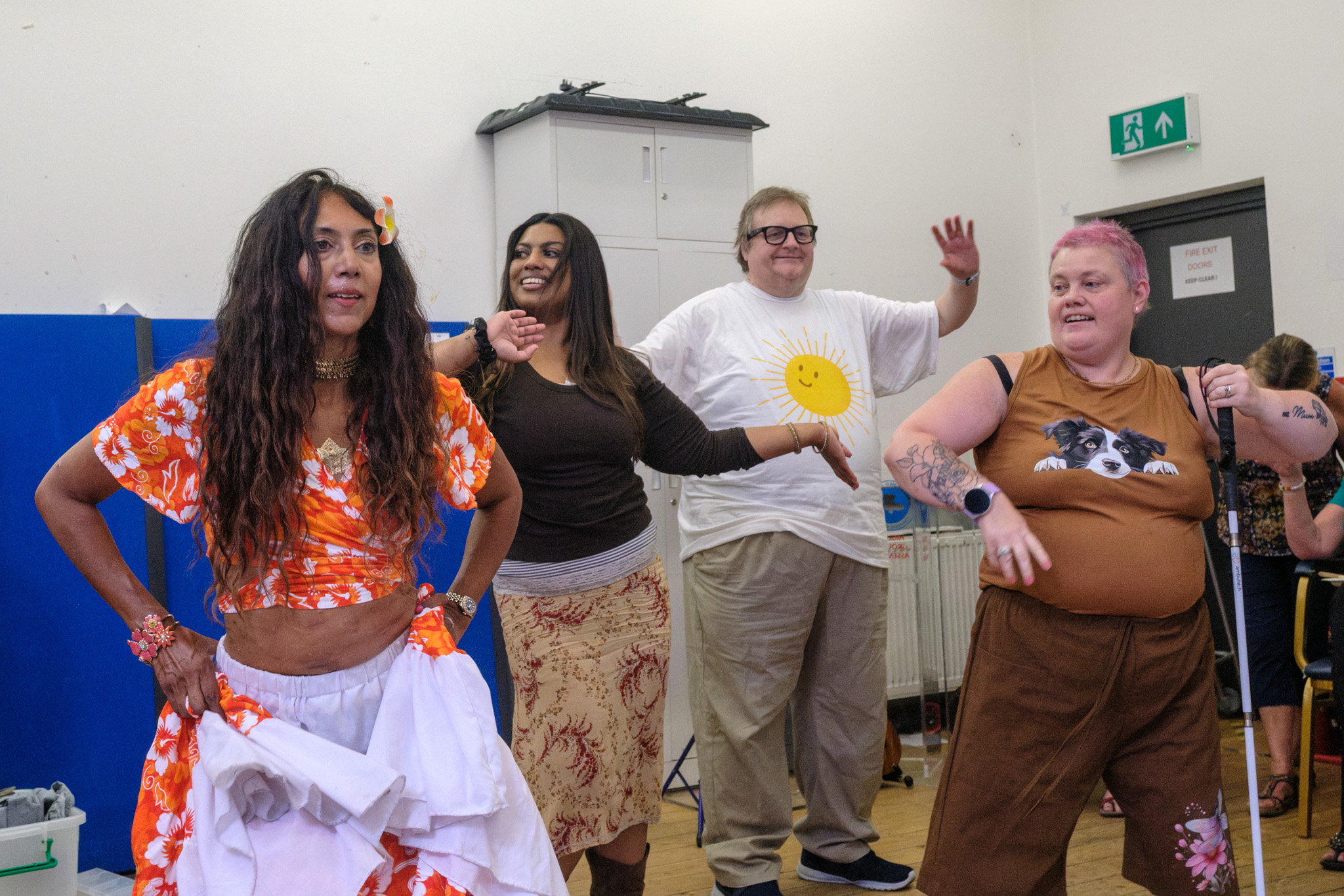 Nisha leading three guests in Mauritian Sega dance movements during the Summer BBQ.